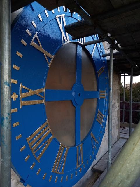 Clock face repainted and in place